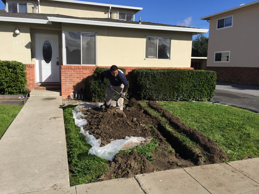 Plumber replacing a water line in front of a San Jose home