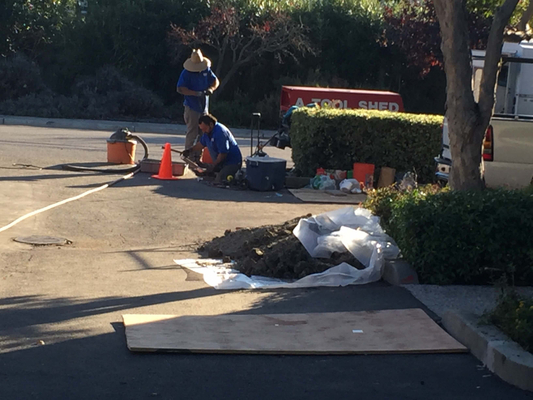 Plumbers working on a trenchless water main replacement