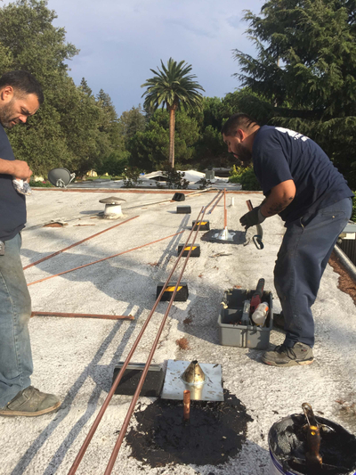 Plumber installing new copper pipes
